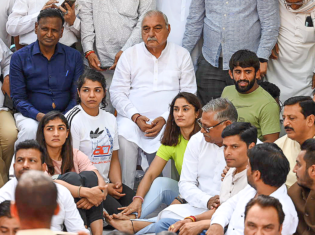 Former Haryana chief minister and Congress leader Bhupinder Singh Hooda with wrestlers Vinesh Phogat, Sakshi Malik, Bajrang Punia and others during their protest at Jantar Mantar, in New Delhi, on Tuesday, April 25.