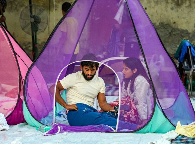 Bajrang Punia and Sangeeta Phogat wake up in their tent at the protest site on Thursday