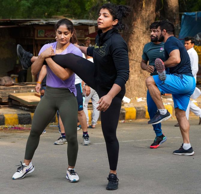  Wrestlers Vinesh Phogat and Sakshi Malik exercise ahead of their sit-in protest on Thursday