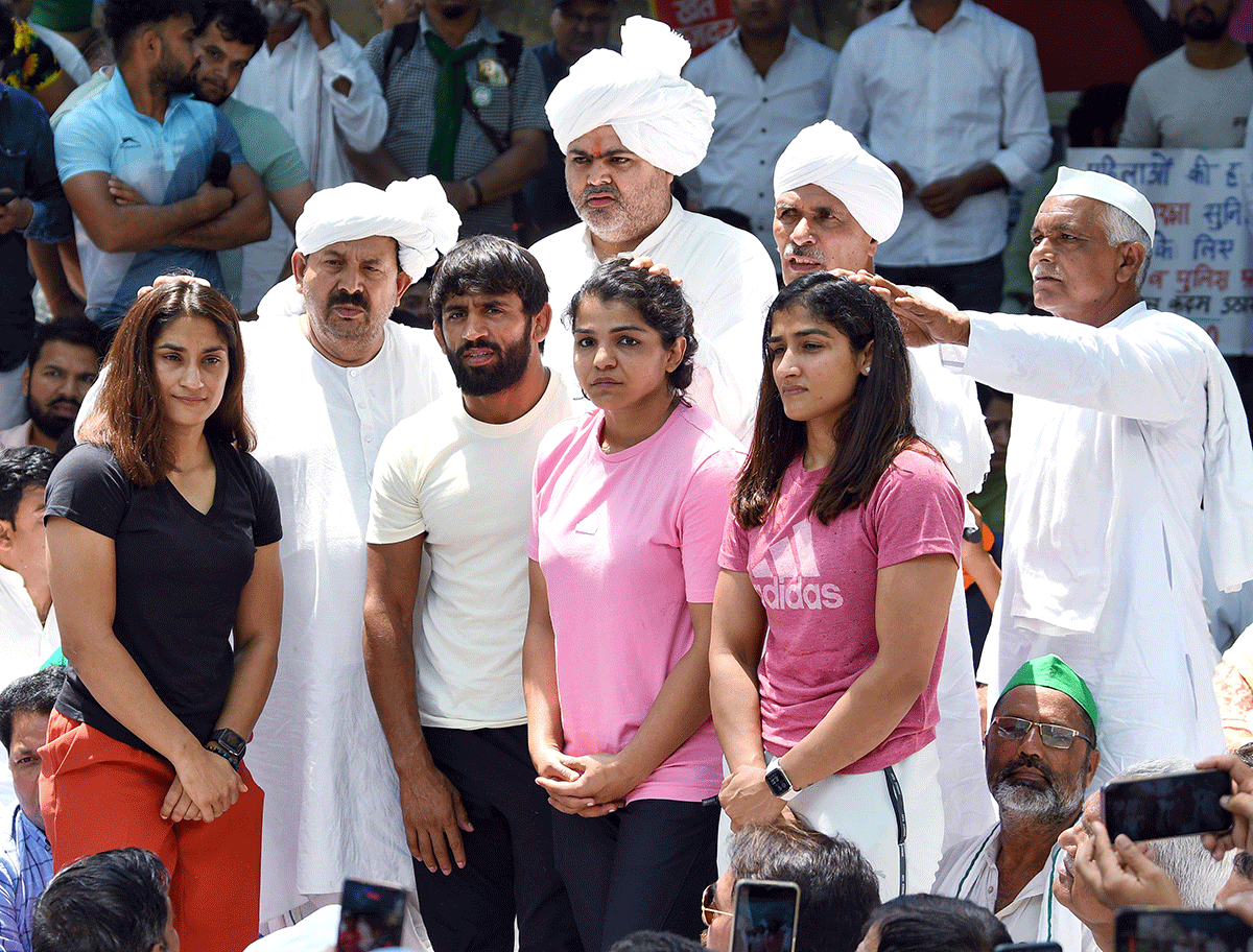 Bhartiya Kisan Union president Naresh Tikait and others give blessings to wrestlers including Bajrang Punia, Sakshi Malik, Vinesh Phogat during their protest at Jantar Mantar in New Delhi on Thursday