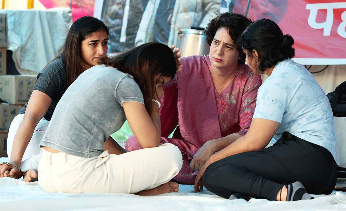 Congress General Secretary Priyanka Gandhi Vadra interacts with wrestlers Sakshi Malik, Vinesh Phogat and others during their protest against the Wrestling Federation of India (WFI) chief Brij Bhushan Singh, at Jantar Mantar in New Delhi on Saturday.