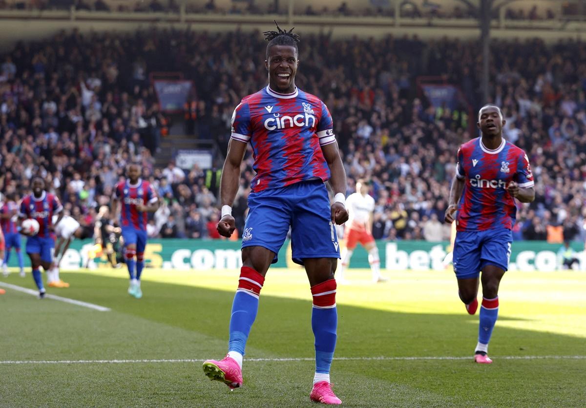 Wilfried Zaha celebrates scoring Crystal Palace's second goal with Tyrick Mitchell at Selhurst Park, London.