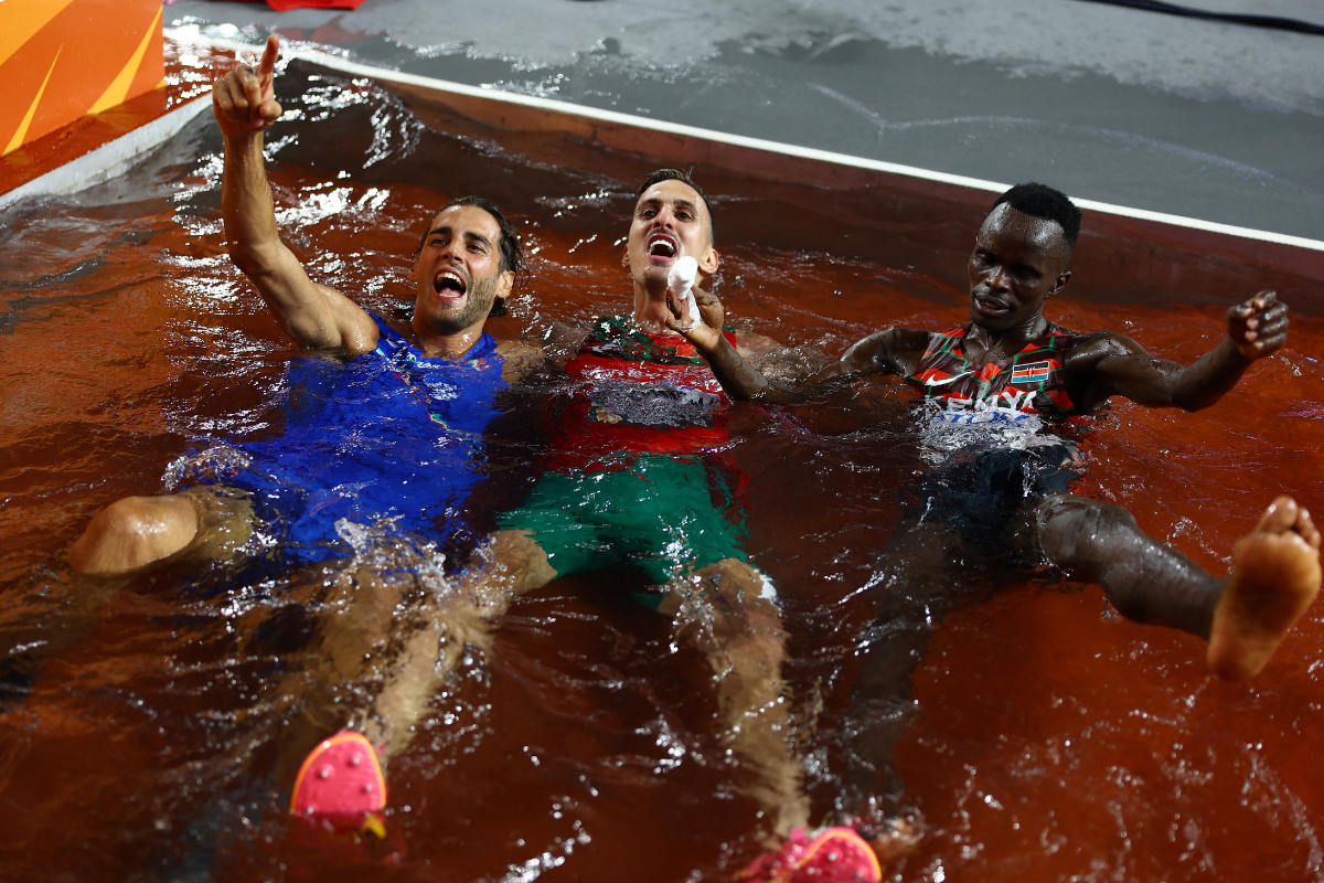 Men's high jump gold medallist Italy's Gianmarco Tamberi, men's 3000m steeplechase gold medallist Morocco's Soufiane El Bakkali and bronze medallist Kenya's Abraham Kibiwot celebrate after the finals on Tuesday, August 22. 