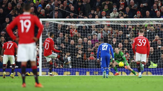 Marcus Rashford scores Manchester United's third goal from the penalty spot.