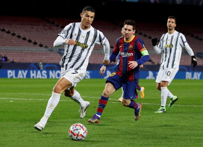 Lionel Messi battles for possession with Cristiano Ronaldo during a Champions League match between FC Barcelona and Juventus, at Camp Nou, Barcelona, Spain, on December 8, 2020.