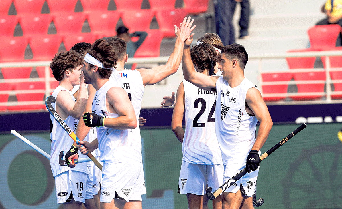 New Zealand players celebrate a goal against Chile