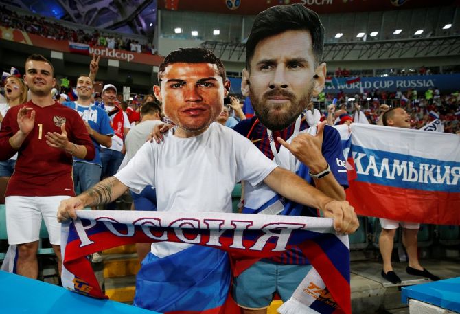 Fans wear masks of Cristiano Ronaldo and Lionel Messi before the World Cup quarter-final between Russia and Croatia, at Fisht Stadium, Sochi, Russia, on July 7, 2018.
