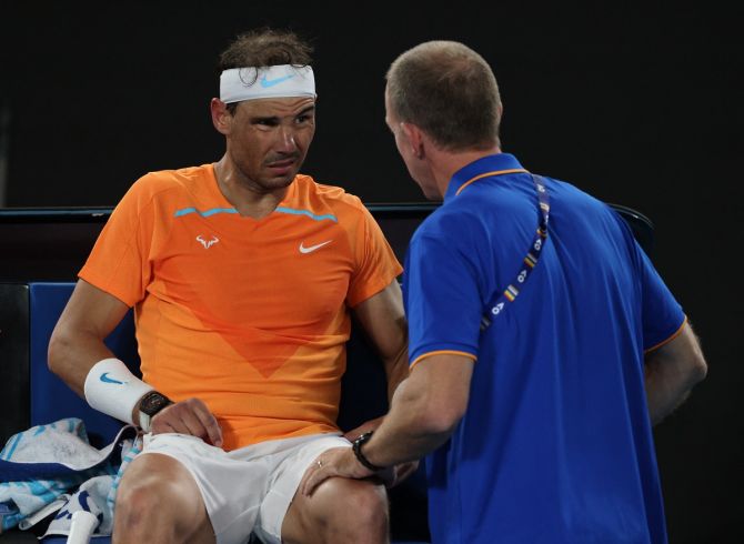 Rafael Nadal receives medical attention after sustaining an injury during the second set.
