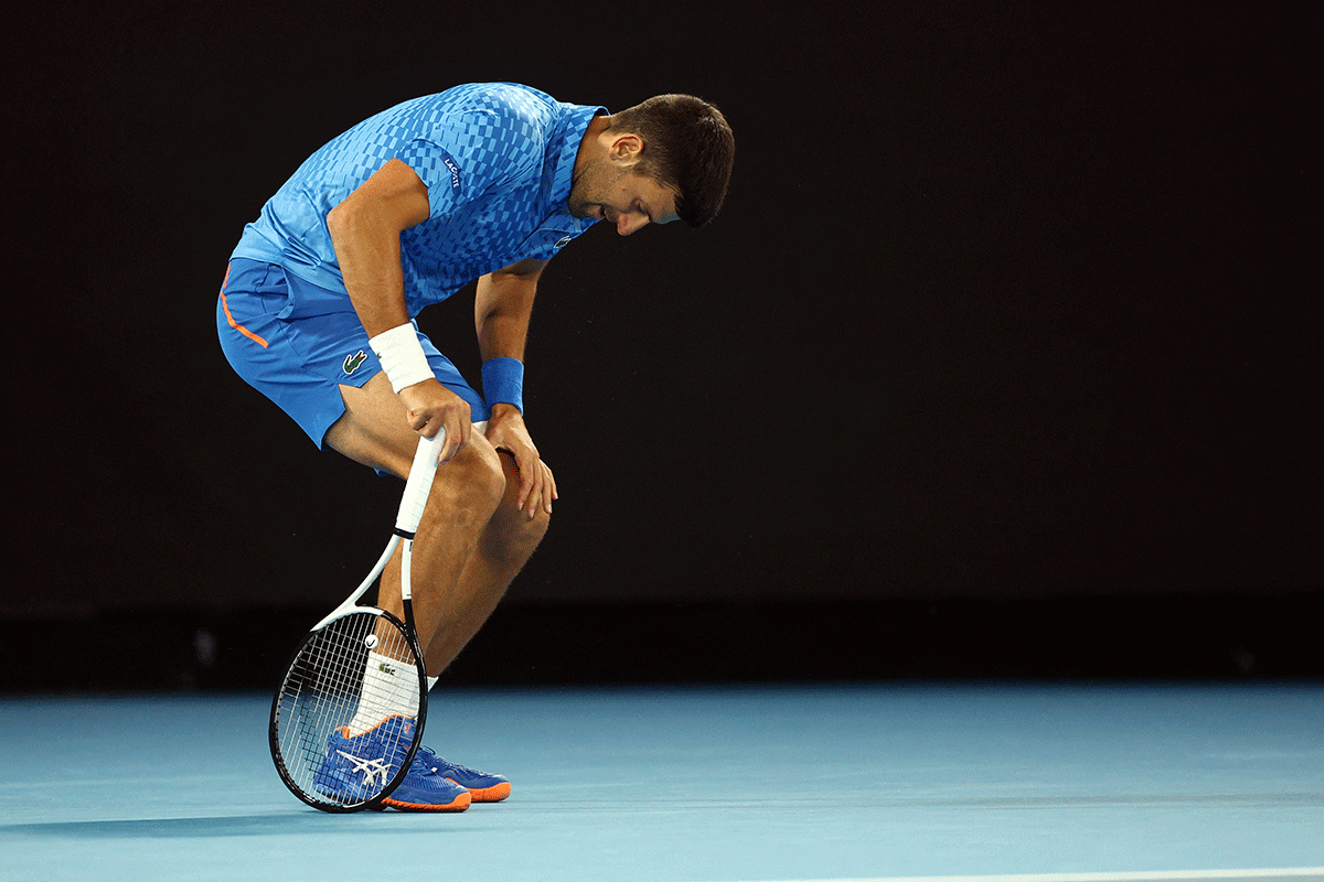 Serbia's Novak Djokovic grimaces in pain during his second round match against France's Enzo Couacaud at the Australian Open on Thursday