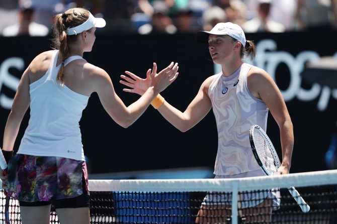 Elena Rybakina, left, and Iga Swiatek meet at the net after their fourth round match.