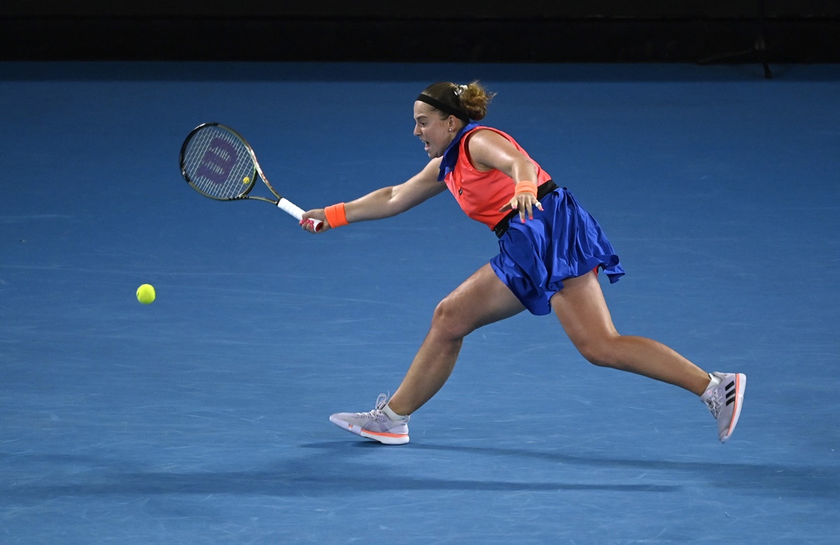 Jelena Ostapenko stretches at the baseline to return a volley from Elena Rybakina.