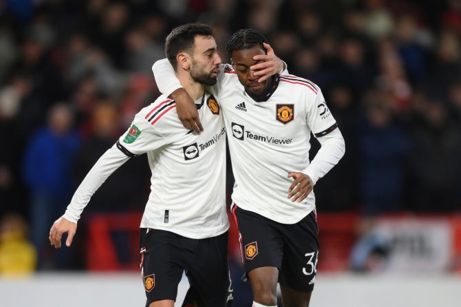 Bruno Fernandes celebrates with Anthony Elanga after scoring Manchester United's third goal.