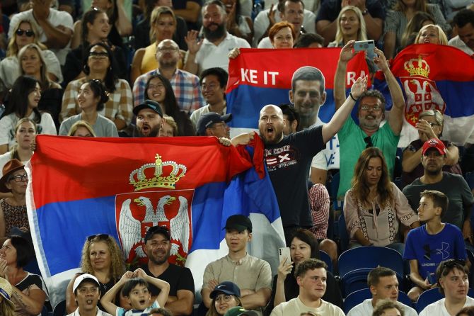 Spectators with Serbian flags cheer Novak Djokovic during his men's singles quarter-final against Andrey Rublev at the 2023 Australian Open. 