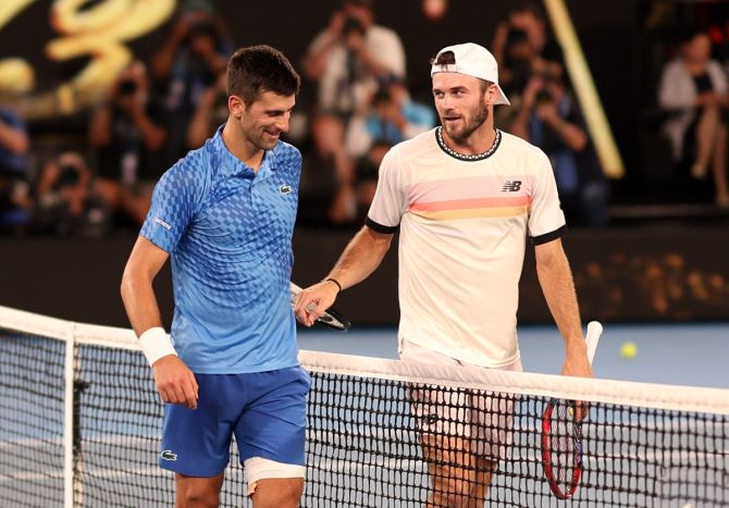 Novak Djokovic and Tommy Paul share a light moment after their semi-final.
