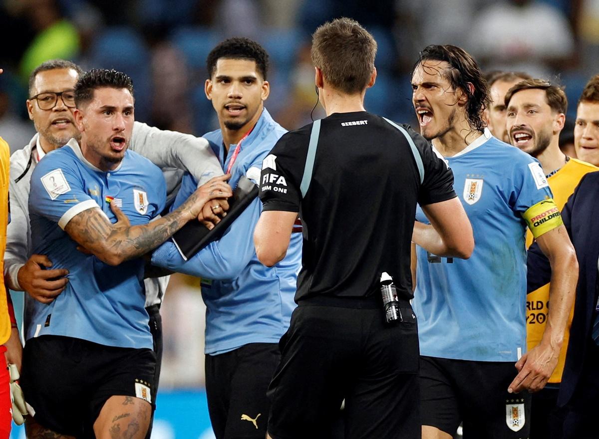 Uruguay's Jose Maria Gimenez and Edinson Cavani remonstrate with referee Daniel Siebert after the FIFA World Cup Group H match against Ghana at Al Janoub Stadium, Al Wakrah, Qatar, on December 2, 2022.