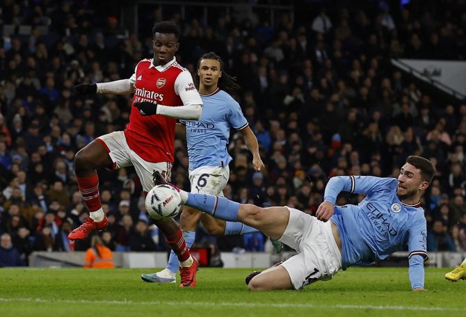Arsenal's Eddie Nketiah is checked by Manchester City's Aymeric Laporte as he makes a run into the box.
