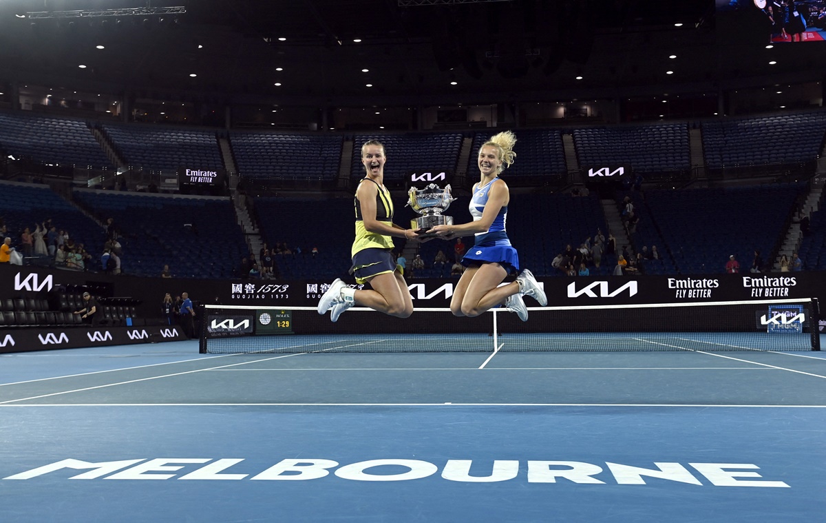 The Czech Republic's Barbora Krejcikova and Katerina Siniakova celebrate with the trophy after winning the Australian Open women's doubles final against Japan's Shuko Aoyama and Ena Shibahara, Melbourne Park, on Sunday.