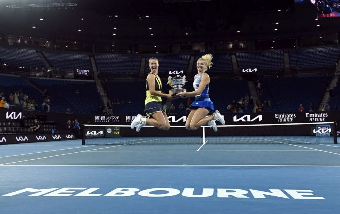 The Czech Republic's Barbora Krejcikova and Katerina Siniakova celebrate with the trophy after winning the Australian Open women's doubles final against Japan's Shuko Aoyama and Ena Shibahara, Melbourne Park, on Sunday.