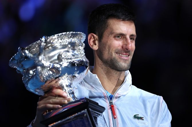 Serbia's Novak Djokovic poses with the Norman Brookes Challenge Cup after winning the Australian Open men's singles final against Greece's Stefanos Tsitsipas at Melbourne Park on Sunday.