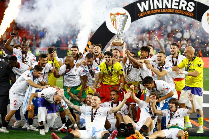 Sevilla players celebrate with the trophy after winning the Europa League at the Puskas Arena, Budapest, Hungary, on Wednesday 