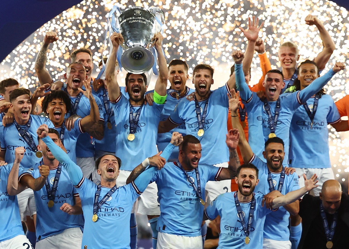 Manchester City's Ilkay Gundogan lifts the trophy as he celebrates with teammates after winning the Champions League.