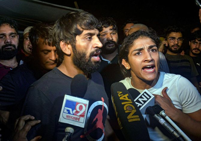 Wrestlers Bajrang Punia and Sangita Phogat talk to the media after the scuffle on Wednesday