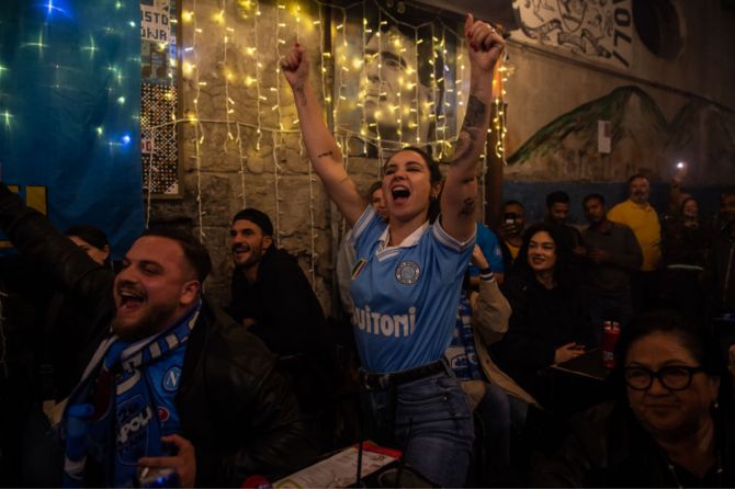 Napoli fans celebrate after winning the Serie A championship near the mural of Diego Armando Maradona in Naples, Italy, on Thursday. SSC Napoli are Champions of Italy after thirty three years; the last time they obtained the trophy, Diego Armando Maradona led the team. The victory of the third Scudetto comes for the team coached by Luciano Spalletti, obtaining 1 point away at the Friuli stadium against Udinese.