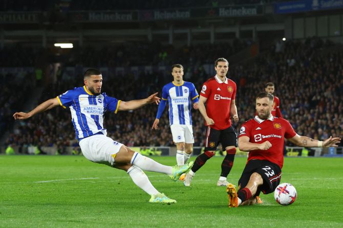 Brighton & Hove Albion's Facundo Buonanotte is challenged by Manchester United's Luke Shaw