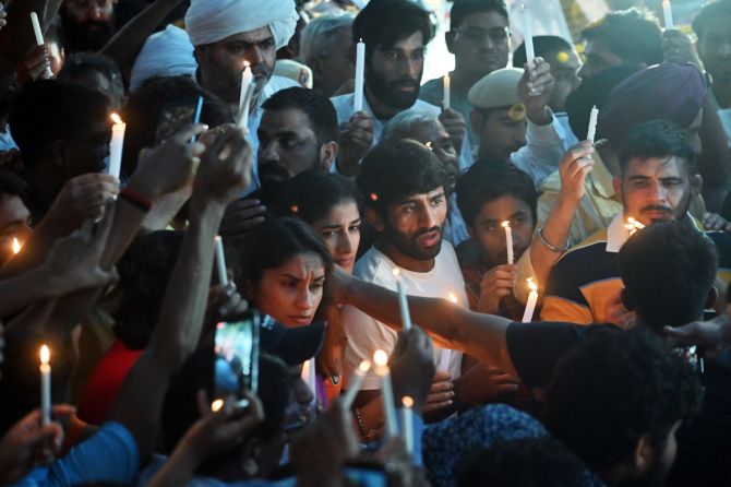 Wrestlers Bajrang Punia, Vinesh Phogat, Sangeeta Phogat, and others during a candle march in view of wrestlers' protest against the alleged sexual harassment of players by WFI chief and BJP MP Brij Bhushan Sharan Singh at Jantar Mantar, in New Delhi on Sunday.