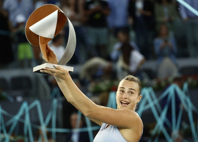 Belarus's Aryna Sabalenka celebrates with the trophy after beating Poland's Iga Swiatek in the final of the Madrid Open, at Park Manzanares, Madrid, on Saturday.