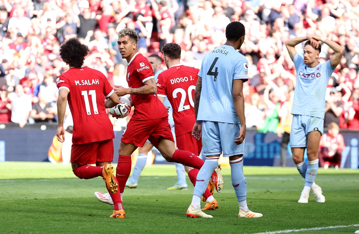 Roberto Firmino celebrates scoring the equaliser for Liverpool's with Mohamed Salah and Diogo Jota against Aston Villa at Anfield, Liverpool.