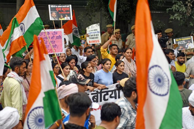 Vinesh Phogat, Sakshi Malik and Bajrang Punia march to India Gate alongside supporters on Tuesday