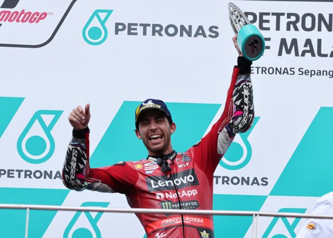 Ducati Lenovo Team's Enea Bastianini celebrates on the podium with a trophy after winning the Malaysian Grand Prix, at Sepang International Circuit, Sepang.
