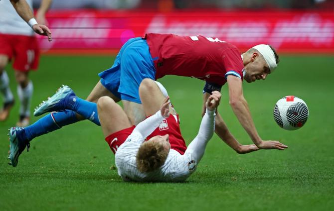 The Czech Republic's Tomas Soucek and Poland's Adam Buksa battle for the ball durung the Group E qualifier at PGE Narodowy, Warsaw, Poland. 