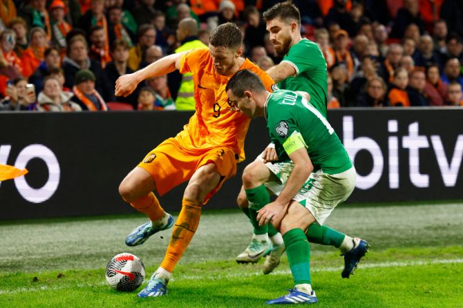 Netherlands' Wout Weghorst in action with Ireland's Josh Cullen durig their Euro 2024 Qualifier Group B match at  Johan Cruyff Arena, Amsterdam, Netherlands on Saturday 