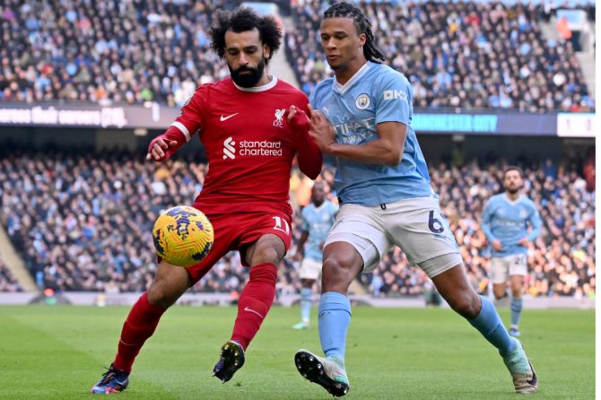 Liverpool's Mohamed Salah and Manchester City's Nathan Ake vie for possession