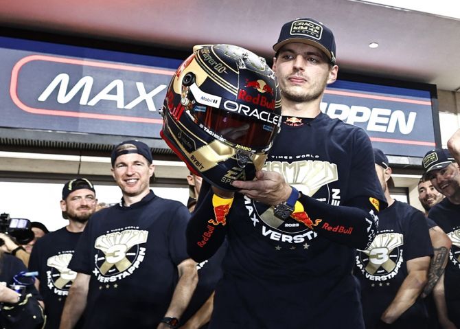 Max Verstappen celebrates with his team after securing his third Formula One World championship.