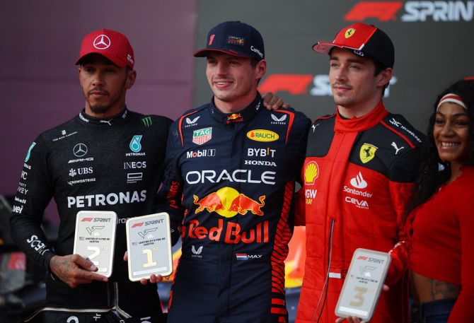 Red Bull's Max Verstappen poses after winning the Formula One United States Grand Prix sprint race alongside second-placed Lewis Hamilton of Mercedes, third-placed Ferrari's Charles Leclerc and track athlete Sha'Carri Richardson, at Circuit of the Americas, Austin, Texas, on Saturday.