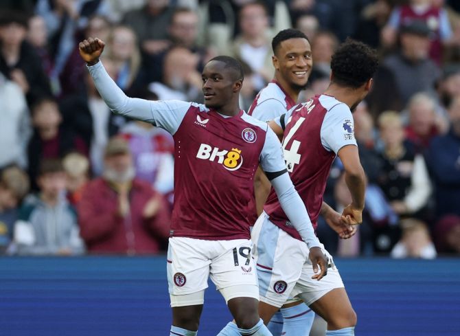 Moussa Diaby celebrates scoring Aston Villa's second goal against Luton Town with Ezri Konsa and Boubacar Kamara.