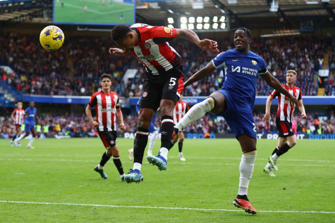 Ethan Pinnock heads the ball home for Brentford's first goal in the Premier League match against Chelsea at Stamford Bridge, London, on Saturday.