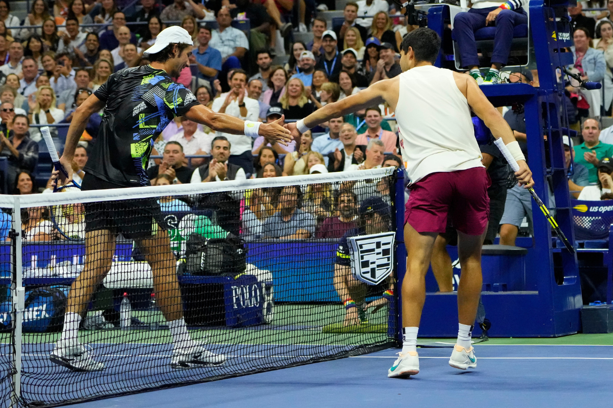 Spain's Carlos Alcaraz and South Africa's Lloyd Harris meet at the net after a close net play in the 3rd set 