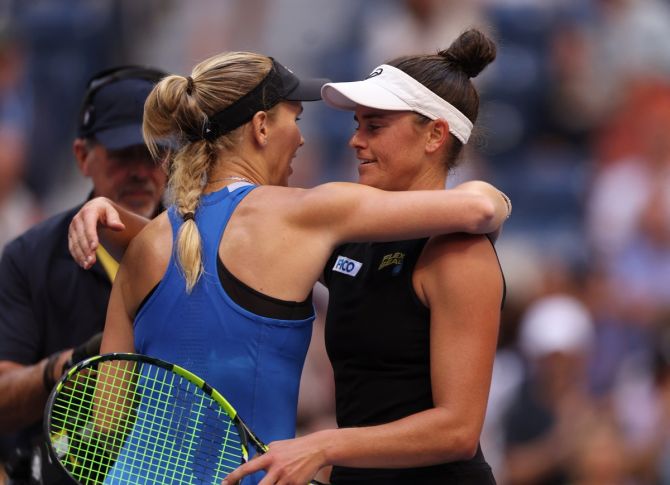 Caroline Wozniacki and Jennifer Brady embrace at the net after their third round match.