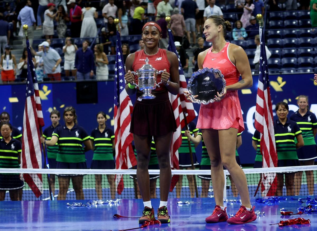 Coco Gauff and Aryna Sabalenka pose with their trophies