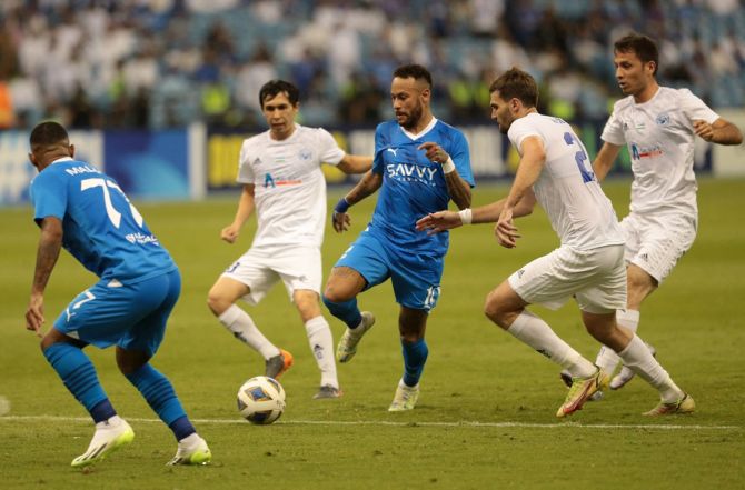 Al Hilal's Neymar in action with Navbahor Namangan's Igor Golban during the Group D match at King Fahd International Stadium, Riyadh.