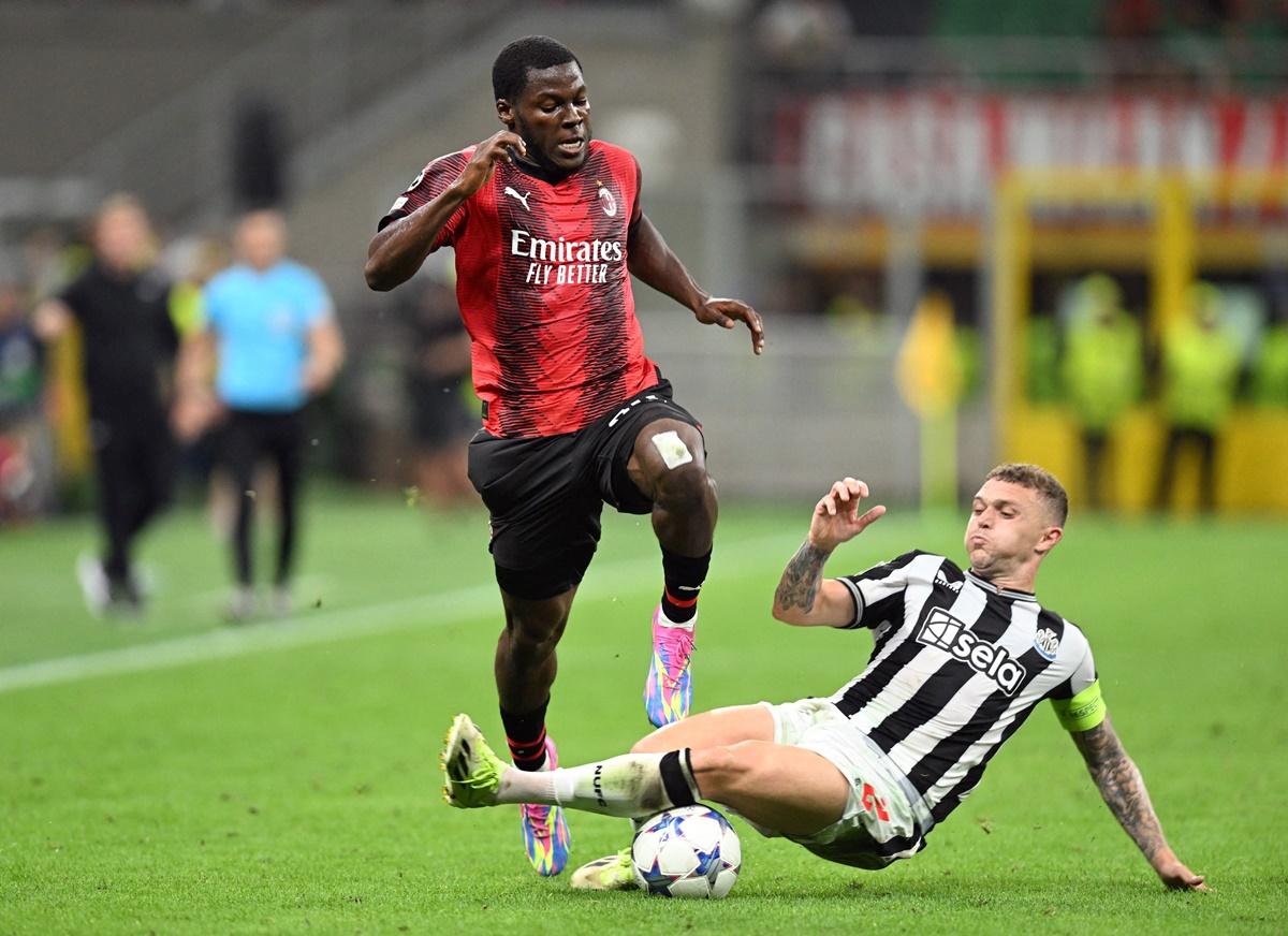 AC Milan's Yunus Musah is tacked by Newcastle United's Kieran Trippier during the Group F match at San Siro, Milan.