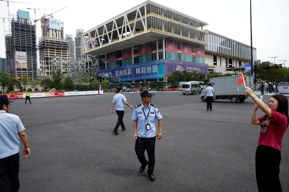 Police officers walk on a street following the torch relay, ahead of the 19th Asian Games Hangzhou 2022, in Zhejiang province, China, on September 20,