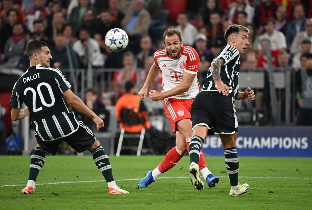 Bayern Munich's Harry Kane fires the ball past Manchester United's Diogo Dalot during the Champions League Group A match at Allianz Arena, Munich, on Wednesday.