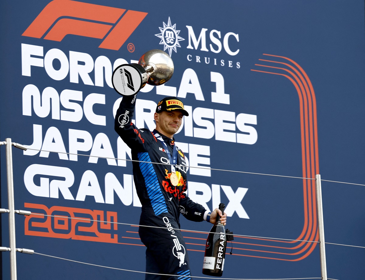 Red Bull's Max Verstappen celebrates with the trophy on the podium after winning the Japanese Grand Prix at Suzuka Circuit, Suzuka, on Sunday.