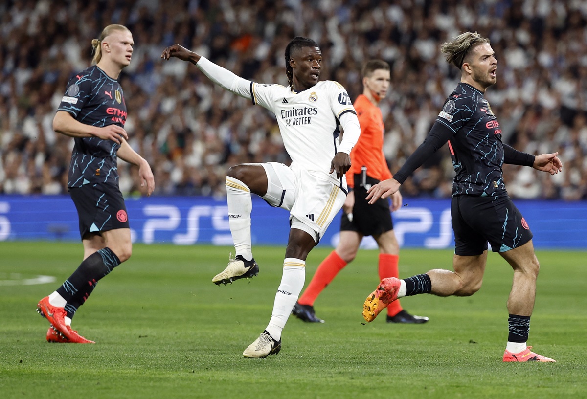 Real Madrid's Eduardo Camavinga scores with a long-range strike, the ball deflecting off defender Ruben Dias in the Champions League quarter-final first leg against Manchester City at the Santiago Bernabeu, Madrid.