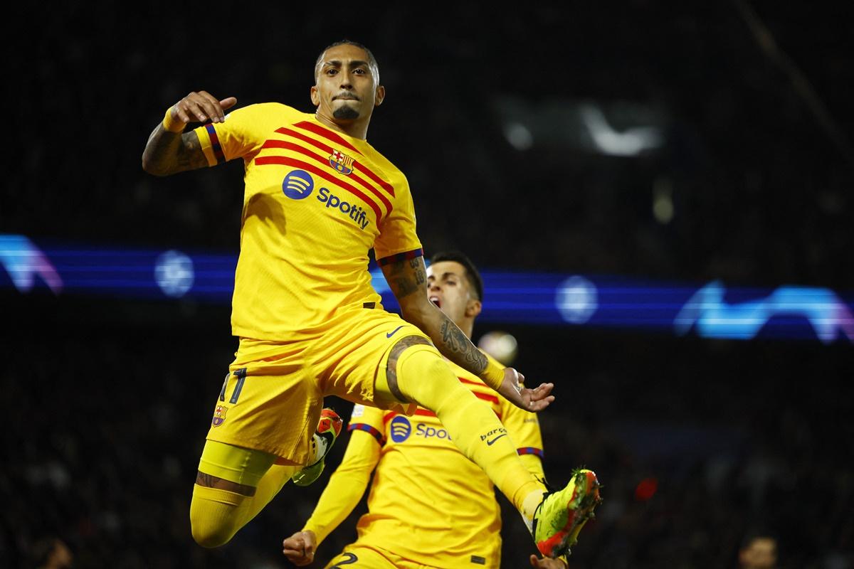 Raphinha celebrates scoring Barcelona's second goal with Joao Cancelo during the Champions League quarter-final first leg against Paris St Germain, at Parc des Princes, Paris, on Wednesday.